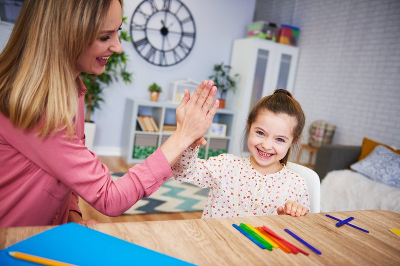 mother teaching kid with postive reinforcement